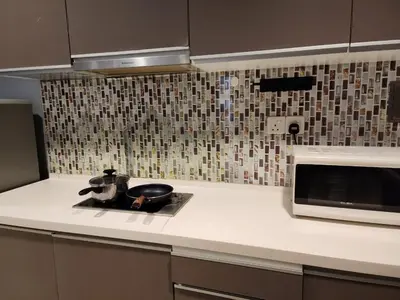 a kitchen with a sink and a microwave at Regalia Suites KL Infinity Pool _ by MygeHomes in Kuala Lumpur