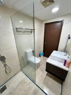 a bathroom with a shower and a toilet and a sink at Regalia Suites KL Infinity Pool _ by MygeHomes in Kuala Lumpur