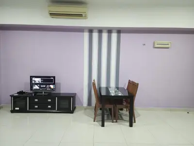 a dining room with a table and a tv at Regalia Suites KL Infinity Pool _ by MygeHomes in Kuala Lumpur