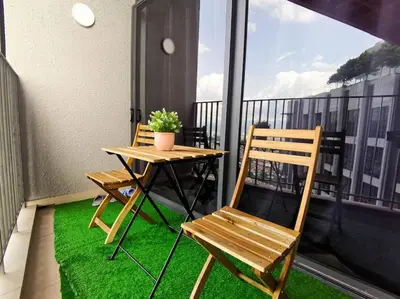 a patio with a table and chairs on a balcony at EkoCheras Loft 5 pax, #Snooker #AboveMall #Balcony #FreeCarPark in Kuala Lumpur