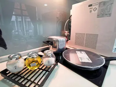 a stove top with two jars of oil and a pan at EkoCheras Loft 5 pax, #Snooker #AboveMall #Balcony #FreeCarPark in Kuala Lumpur