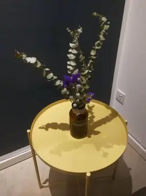 a yellow table with a vase with flowers on it at Bintang Fairlane 2mins PavilionKL TRX KLCC - AJhome in Kuala Lumpur