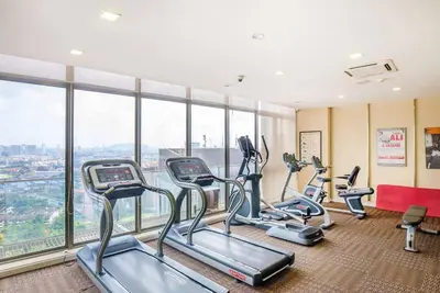 a gym with three cardio machines in a room with windows at Bintang Fairlane 2mins PavilionKL TRX KLCC - AJhome in Kuala Lumpur