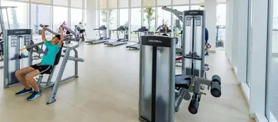 a woman exercising on a treadmill in a gym at Maxhome Plus @ The Platinum KLCC in Kuala Lumpur