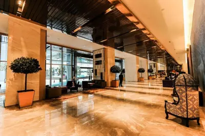 a lobby of a building with people sitting in chairs at Maxhome Plus @ The Platinum KLCC in Kuala Lumpur