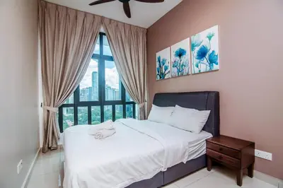 a bedroom with a bed and a large window at Legasi Kampung Baru - Idealhub in Kuala Lumpur