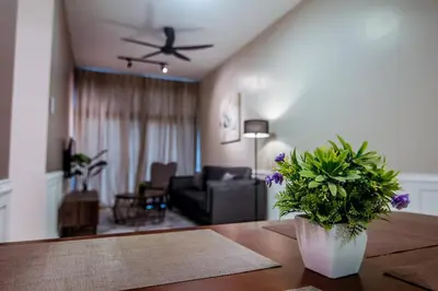 a living room with a couch and a ceiling fan at Legasi Kampung Baru - Idealhub in Kuala Lumpur