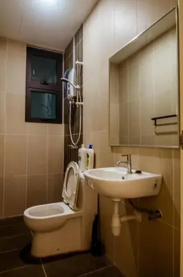 a bathroom with a toilet and a sink at Legasi Kampung Baru - Idealhub in Kuala Lumpur