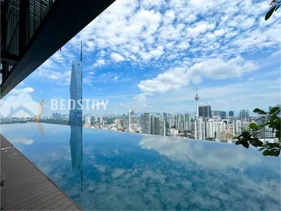a view of the burj khalifa from a swimming pool at Lucentia Residence BBCC By Bedstay in Kuala Lumpur