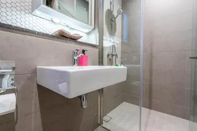 a bathroom with a sink and a shower at Lucentia Residence BBCC By Bedstay in Kuala Lumpur