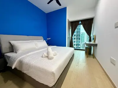a bedroom with a bed with two stuffed animals on it at Eaton Residences KLCC in Kuala Lumpur