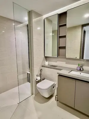 a bathroom with a toilet and a sink and a shower at Eaton Residences KLCC in Kuala Lumpur