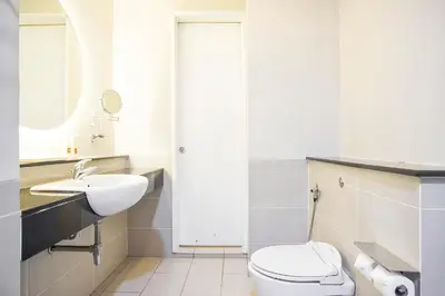 a white bathroom with a toilet and a sink at SG Residence Bukit Bintang in Kuala Lumpur
