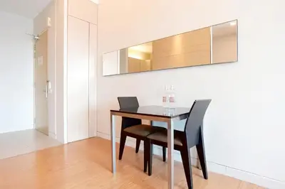 a dining room with a table and a laptop on it at SG Residence Bukit Bintang in Kuala Lumpur