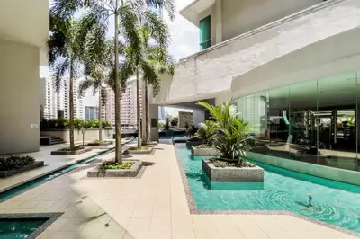 an indoor pool with palm trees in a building at SG Residence Bukit Bintang in Kuala Lumpur