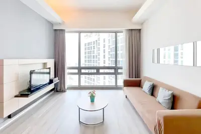a living room with a couch and a tv at SG Residence Bukit Bintang in Kuala Lumpur