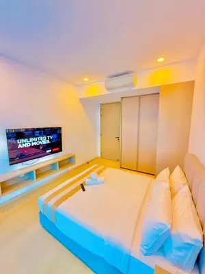 a room with a bed and a tv on a wall at EATON RESIDENCE AT KLCC in Kuala Lumpur