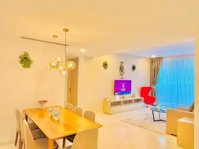 a dining room and living room with a table and a tv at EATON RESIDENCE AT KLCC in Kuala Lumpur
