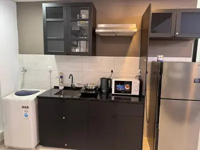 a kitchen with a refrigerator and a microwave at The Robertson S22 Jalan Alor Petaling Street Bukit Bintang KL 3R2B 8Pax in Kuala Lumpur
