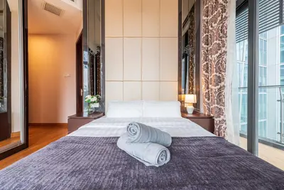 a bedroom with a large bed with towels on it at Dorsett Residence Kuala Lumpur 17 in Kuala Lumpur