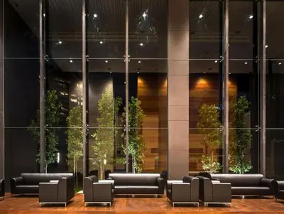 a lobby with black couches in front of a building at Dorsett Residence Kuala Lumpur 14 in Kuala Lumpur