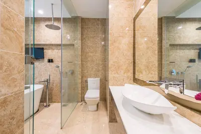 a bathroom with a toilet and a sink and a shower at Dorsett Residence Kuala Lumpur 14 in Kuala Lumpur