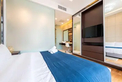 a bedroom with a large bed and a tv at Dorsett Residence Kuala Lumpur 12 in Kuala Lumpur