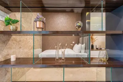 a glass shelf with a bed in a room at Dorsett residence Kuala Lumpur 19 in Kuala Lumpur