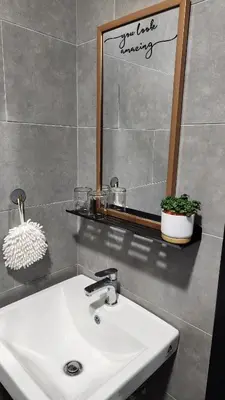 a bathroom with a white sink and a mirror at The Nova by The City Collection in Kuala Lumpur