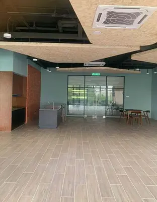 an empty room with a table and chairs in a building at The Nova by The City Collection in Kuala Lumpur