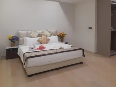 a bedroom with a large bed with flowers on it at Star KLCC by Arman in Kuala Lumpur