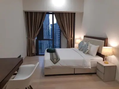 a bedroom with a bed with a view of a city at Star KLCC by Arman in Kuala Lumpur