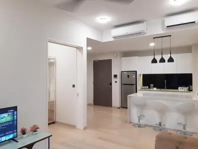 a living room with a kitchen with white walls at Star KLCC by Arman in Kuala Lumpur