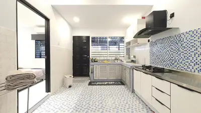 a kitchen with white cabinets and blue tiles on the floor at A Place Like Home Landed House Kuala Lumpur in Kuala Lumpur