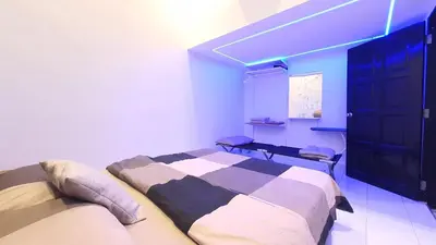 a bedroom with a bed and a black cabinet at A Place Like Home Landed House Kuala Lumpur in Kuala Lumpur
