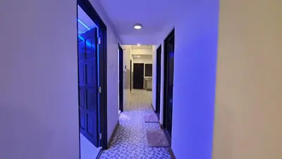 a hallway with blue doors and a tile floor at A Place Like Home Landed House Kuala Lumpur in Kuala Lumpur