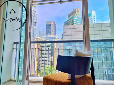 a room with a window with a view of a city at Lila Suites Seri Bukit Ceylon in Kuala Lumpur
