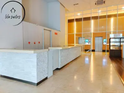 a lobby with a counter in a building at Lila Suites Seri Bukit Ceylon in Kuala Lumpur