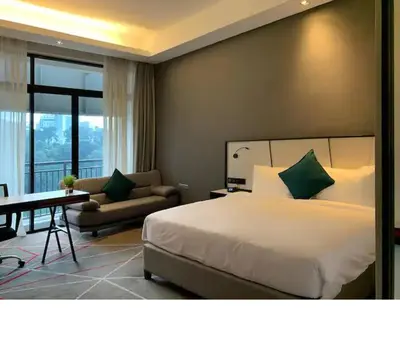 a bedroom with a bed and a couch and a table at M101 Dang Wangi remote work-friendly suite in Kuala Lumpur