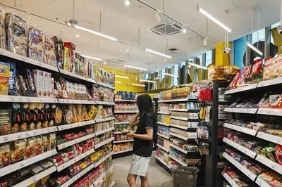 a woman standing in a grocery store aisle at MyRehat Regalia Residences in Kuala Lumpur