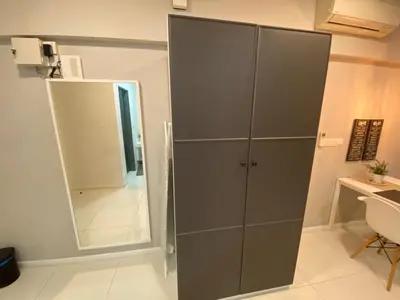 a gray cabinet in a room with a mirror at Summer Suites KLCC By Whollmark in Kuala Lumpur