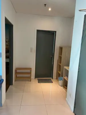 a hallway with a black door and a tile floor at Summer Suites KLCC By Whollmark in Kuala Lumpur