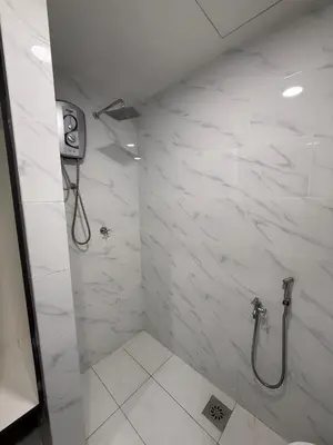 a bathroom with a shower with white marble walls at Prime Suite at Ampang - Individual Private Rooms in Kuala Lumpur