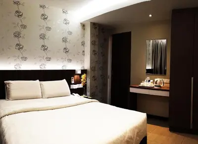 a bedroom with a large white bed in a room at Tai Ichi Hotel Kuala Lumpur in Kuala Lumpur