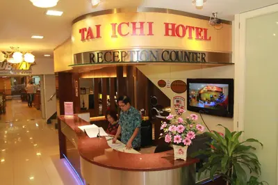 a woman sitting at a reception counter in a hotel at Tai Ichi Hotel Kuala Lumpur in Kuala Lumpur