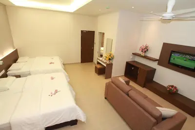 a hotel room with two beds and a flat screen tv at Tai Ichi Hotel Kuala Lumpur in Kuala Lumpur