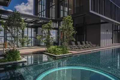 a swimming pool in front of a building at Maxhome Cozy at Lucentia Bukit Bintang City Centre KL in Kuala Lumpur