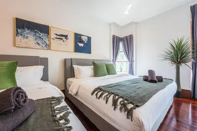 a bedroom with two beds and a palm tree at Tropical Bliss Luxe 5BR 30Pax Private Pool Villa KL by Verano in Kuala Lumpur