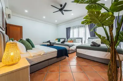 a room with three beds and a plant at Tropical Bliss Luxe 5BR 30Pax Private Pool Villa KL by Verano in Kuala Lumpur