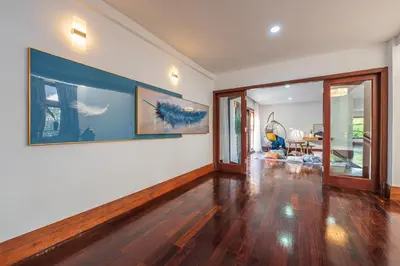 an empty living room with a large painting on the wall at Tropical Bliss Luxe 5BR 30Pax Private Pool Villa KL by Verano in Kuala Lumpur
